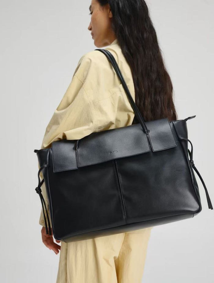 Close-up of a brown leather tote